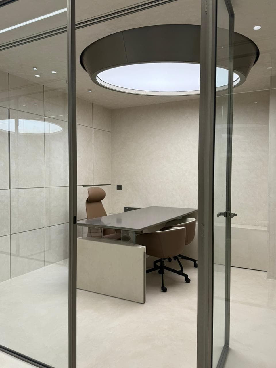 Glass cabin with a round pendant light at Colortale's Faridabad Office project Glass cabin with a round pendant light at Colortale's Faridabad Office project